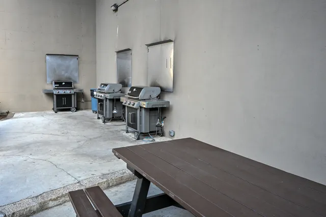 a living room with table chairs and a dining table