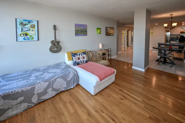 a spacious bedroom with a bed and a table in it