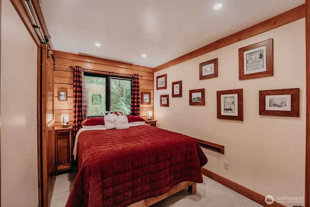 a bedroom with a bed and a lamp next to a window