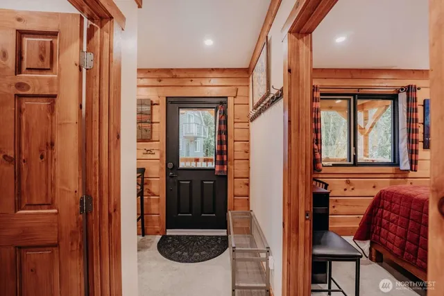 a bedroom with a bed and a large window