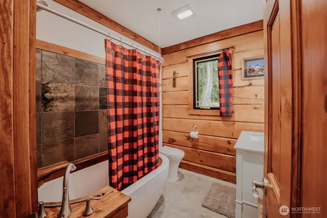 a bathroom with a bathtub and a shower