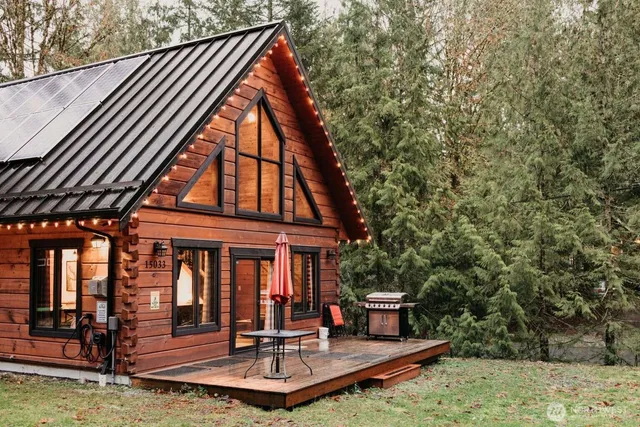 a view of house with swimming pool outdoor seating