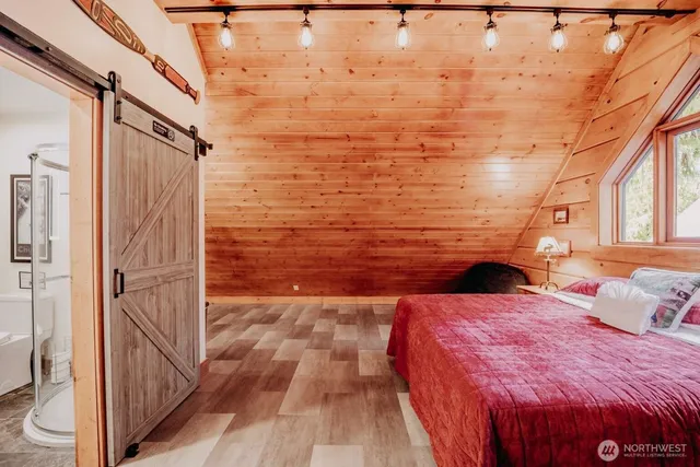 a bedroom with a bed and a refrigerator