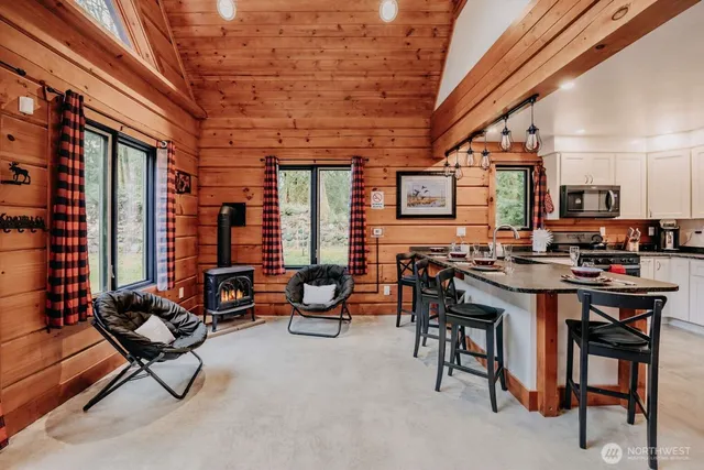 a living room with furniture a flat screen tv and a window