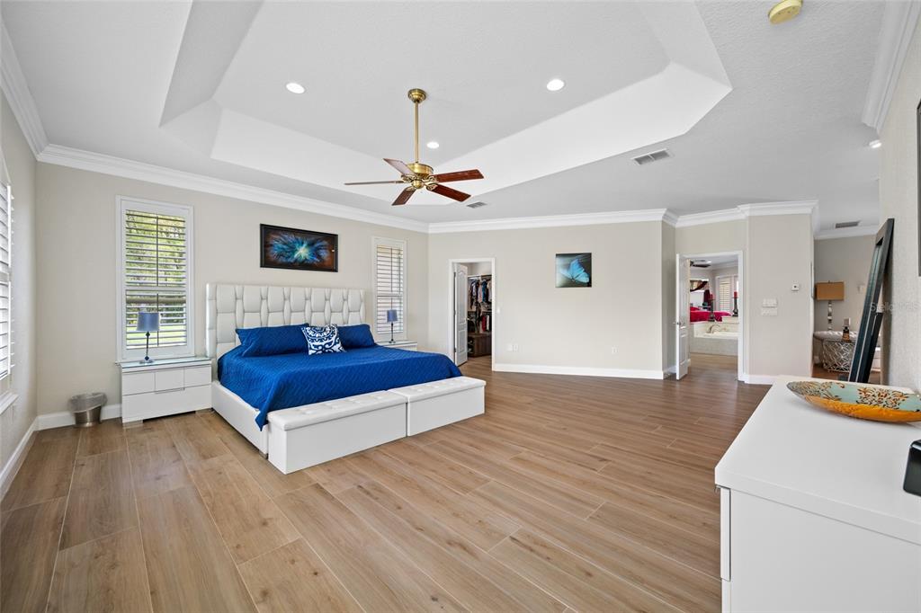 11939 Pasco Trails Boulevard Spring Hill, FL 34610 - Photo 16 of 61 a bedroom with furniture and a wooden floor