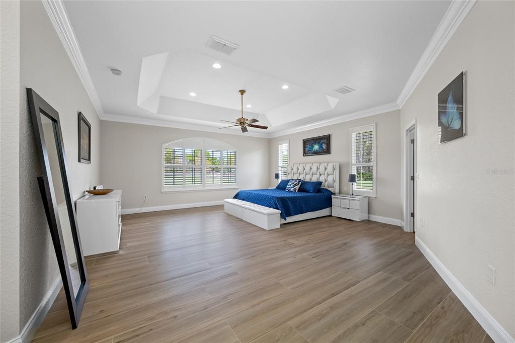 11939 Pasco Trails Boulevard Spring Hill, FL 34610 - Photo 17 of 61 a bedroom with furniture and window