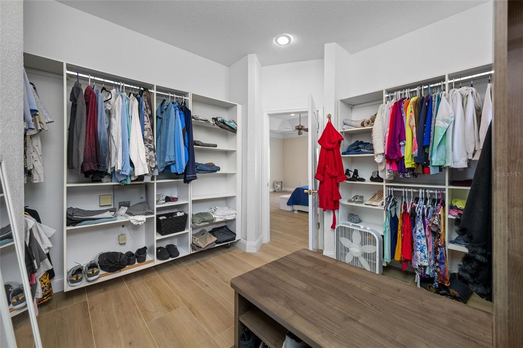 11939 Pasco Trails Boulevard Spring Hill, FL 34610 - Photo 18 of 61 a view of walk in closet with clothes and shoes
