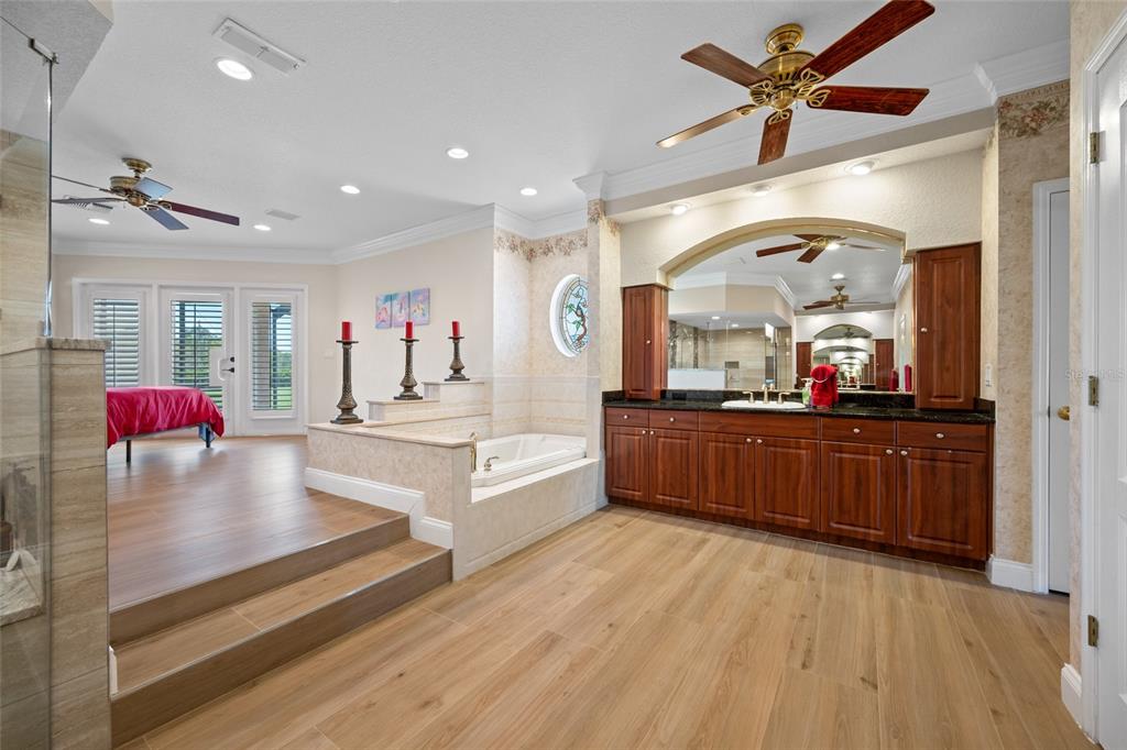 11939 Pasco Trails Boulevard Spring Hill, FL 34610 - Photo 24 of 61 a large kitchen with stainless steel appliances a large counter top a stove and a refrigerator