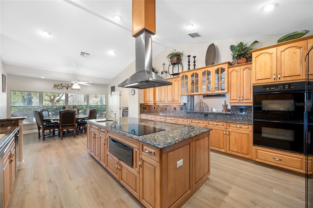 11939 Pasco Trails Boulevard Spring Hill, FL 34610 - Photo 32 of 61 a kitchen with stainless steel appliances granite countertop a stove a sink and a refrigerator