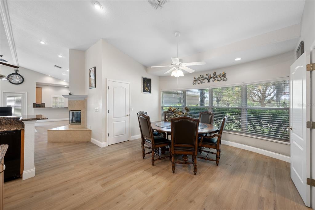 11939 Pasco Trails Boulevard Spring Hill, FL 34610 - Photo 35 of 61 a view of a dining room with furniture window and wooden floor