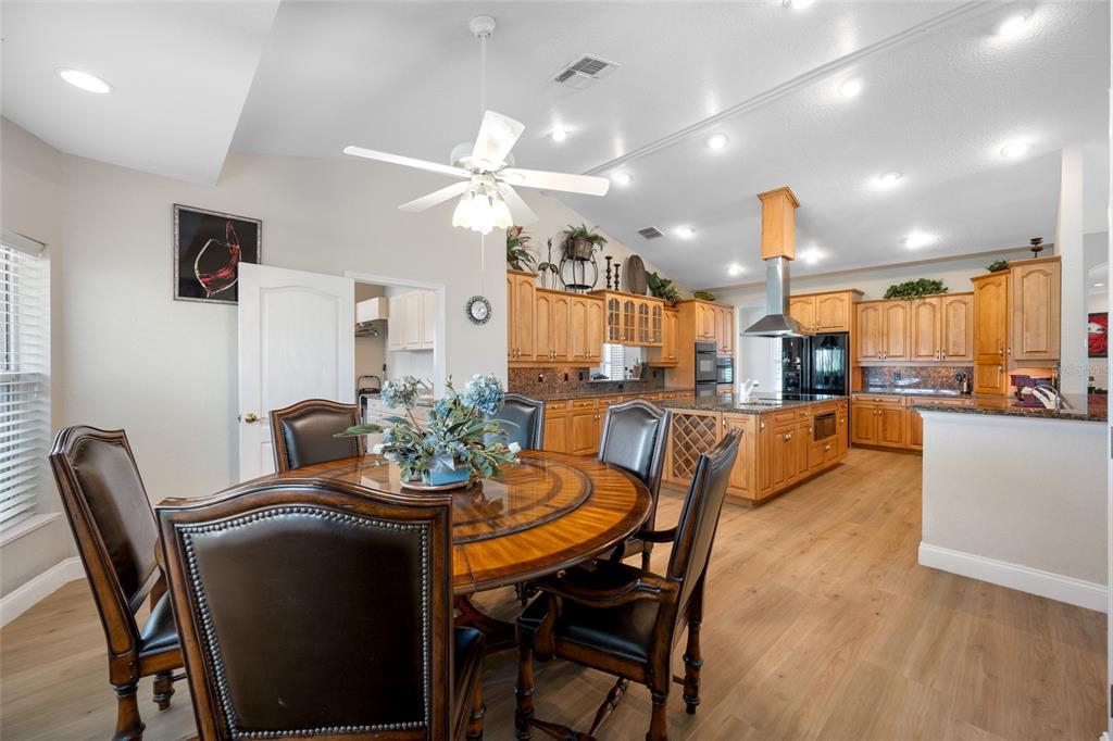 11939 Pasco Trails Boulevard Spring Hill, FL 34610 - Photo 36 of 61 a view of a dining room with furniture