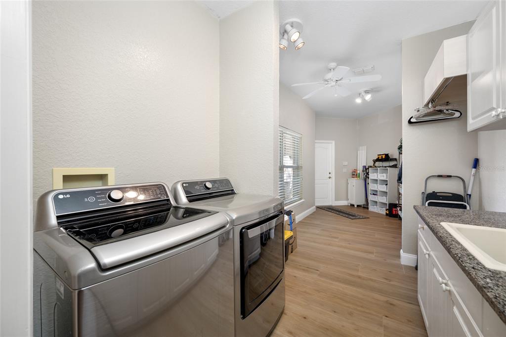 11939 Pasco Trails Boulevard Spring Hill, FL 34610 - Photo 37 of 61 a kitchen that has a stove and a wooden floor