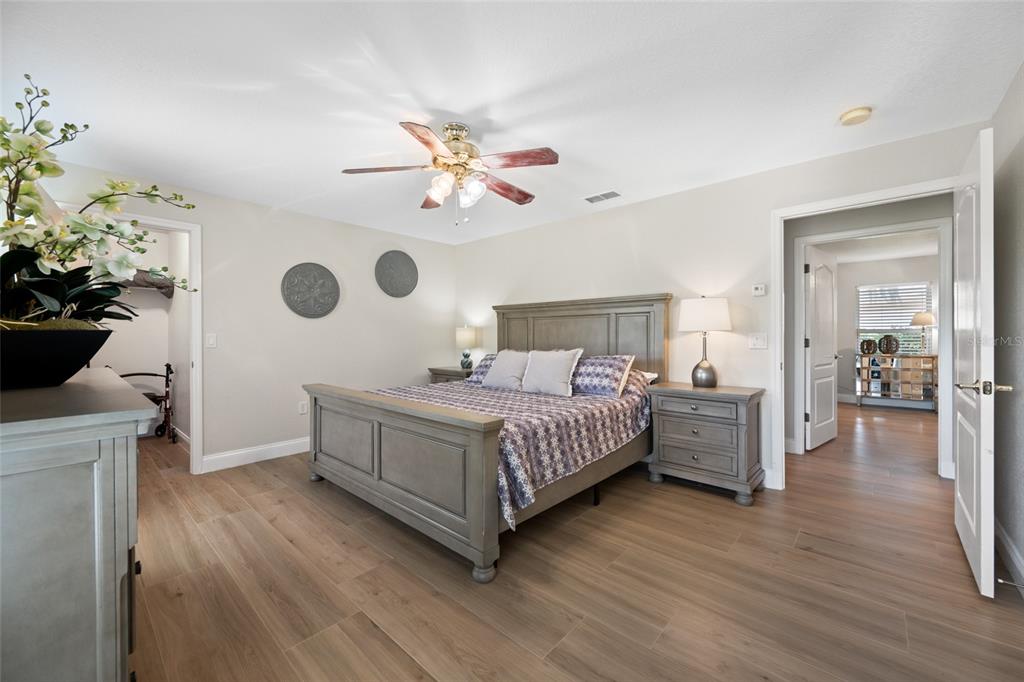 11939 Pasco Trails Boulevard Spring Hill, FL 34610 - Photo 39 of 61 a bedroom with a bed and a chandelier