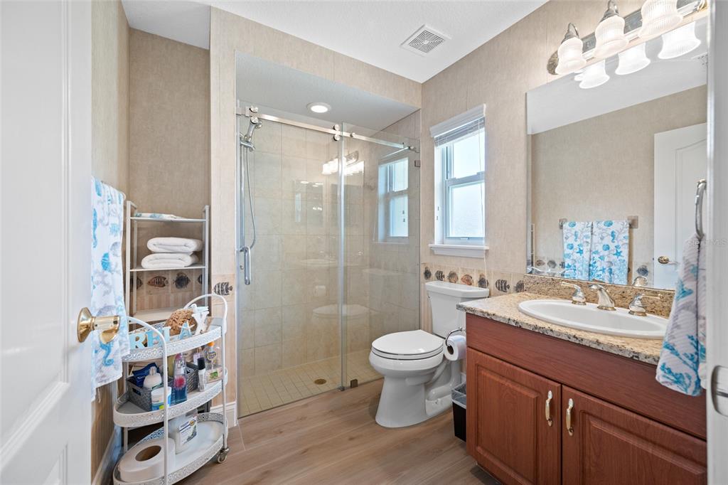 11939 Pasco Trails Boulevard Spring Hill, FL 34610 - Photo 43 of 61 a bathroom with a sink a toilet and shower