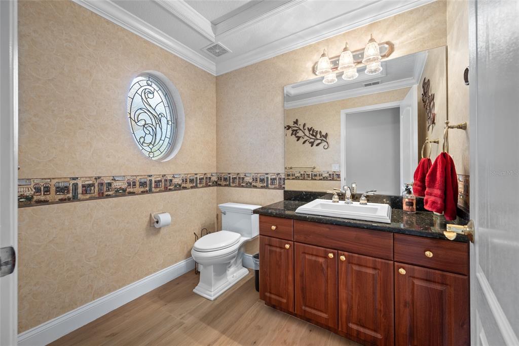 11939 Pasco Trails Boulevard Spring Hill, FL 34610 - Photo 46 of 61 a bathroom with a toilet a sink and a mirror