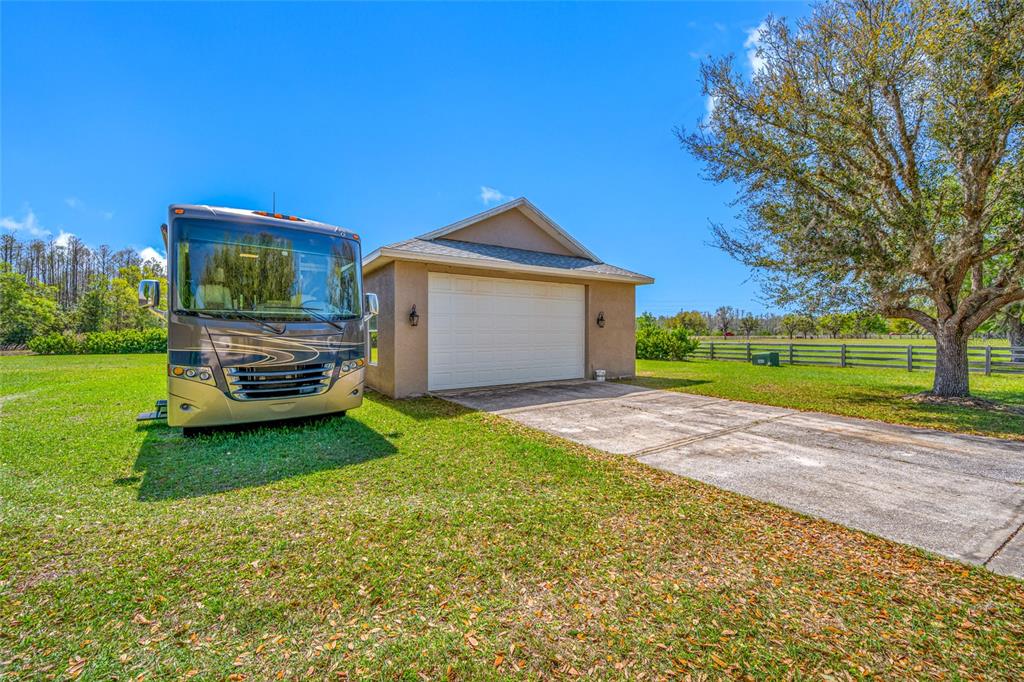 11939 Pasco Trails Boulevard Spring Hill, FL 34610 - Photo 5 of 61 a front view of a house with a garden