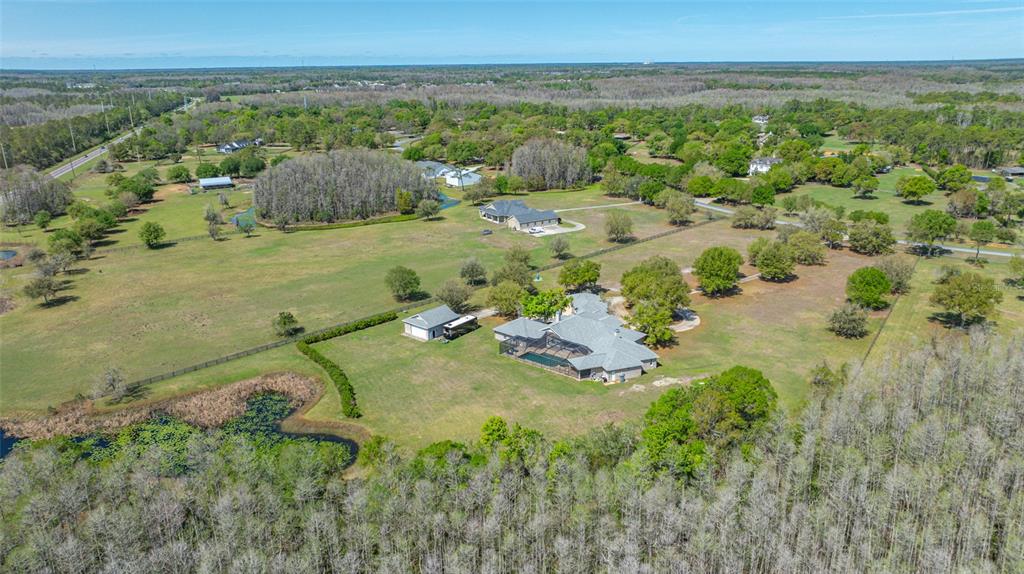 11939 Pasco Trails Boulevard Spring Hill, FL 34610 - Photo 58 of 61 an aerial view of a houses with a yard