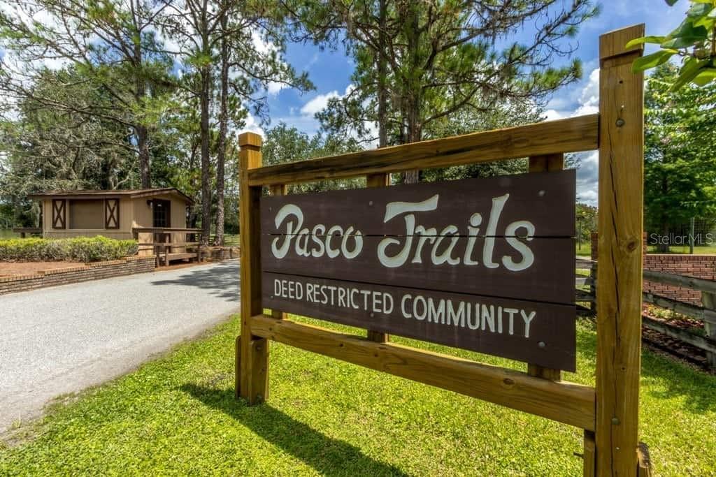 11939 Pasco Trails Boulevard Spring Hill, FL 34610 - Photo 61 of 61 a sign on the side of the road