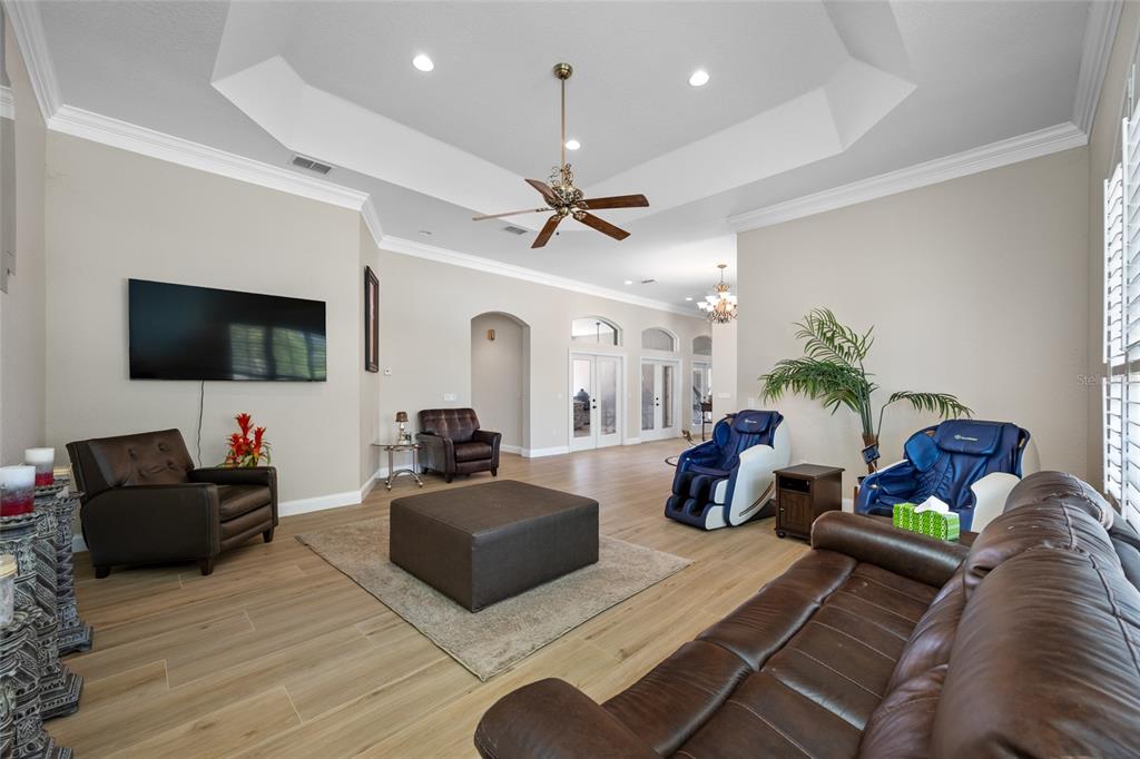 11939 Pasco Trails Boulevard Spring Hill, FL 34610 - Photo 10 of 61 a living room with furniture and a flat screen tv