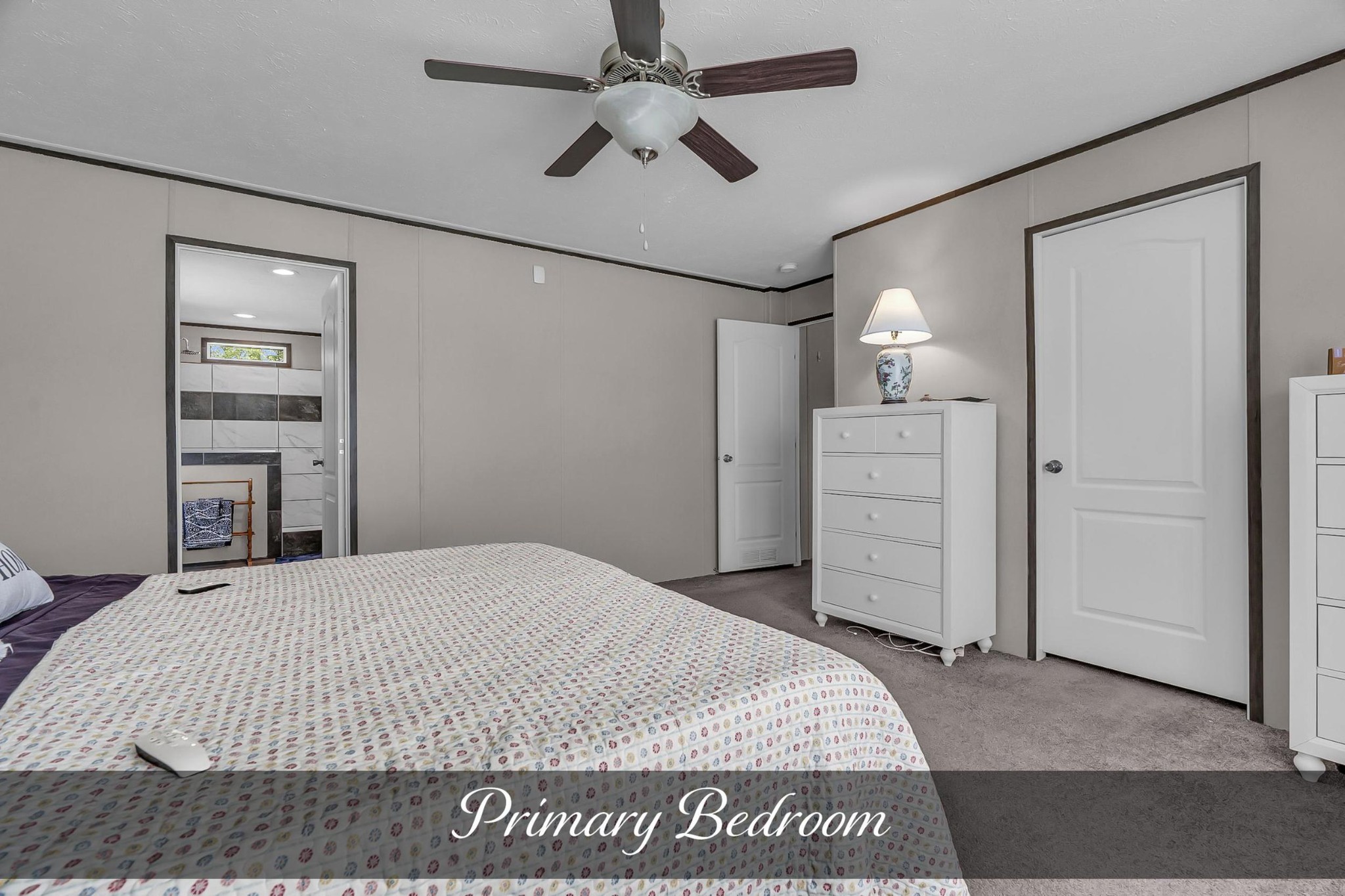 599 Days Road Lafayette, TN 37083 - Photo 11 of 32 a spacious bedroom with a bed and a chandelier