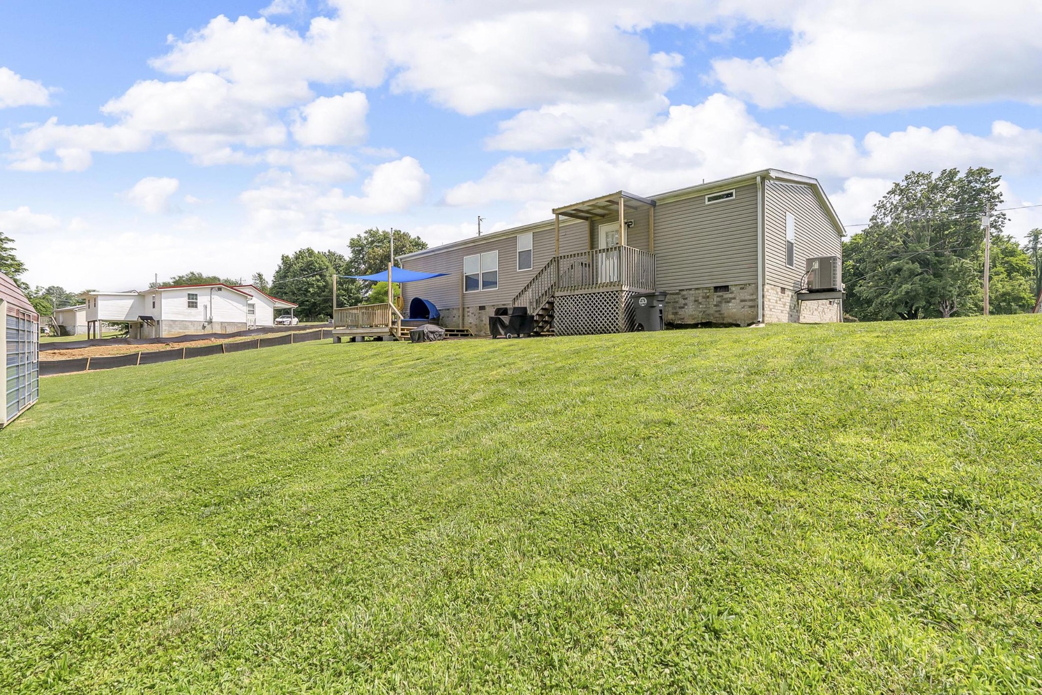 599 Days Road Lafayette, TN 37083 - Photo 21 of 32 a tall white building with a big yard and large trees