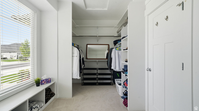 111 East Silver Oak Road Vineyard, UT 84059 - Photo 22 of 50 Walk-in closet featuring built-in shelving, carpet flooring, a window with blinds, and a built-in bench with cubby storage