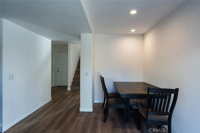 a view of a room with furniture and wooden floor