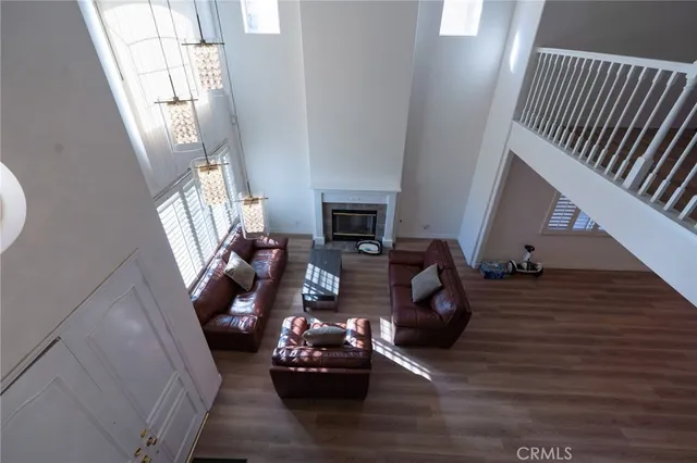 a living room with furniture floor to ceiling window and fireplace