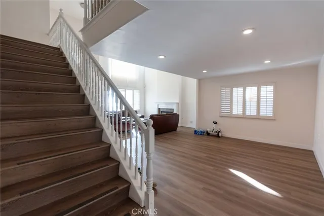 a view of entryway and hall with wooden floor