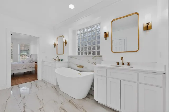 a spacious bathroom with a toilet sink and mirror