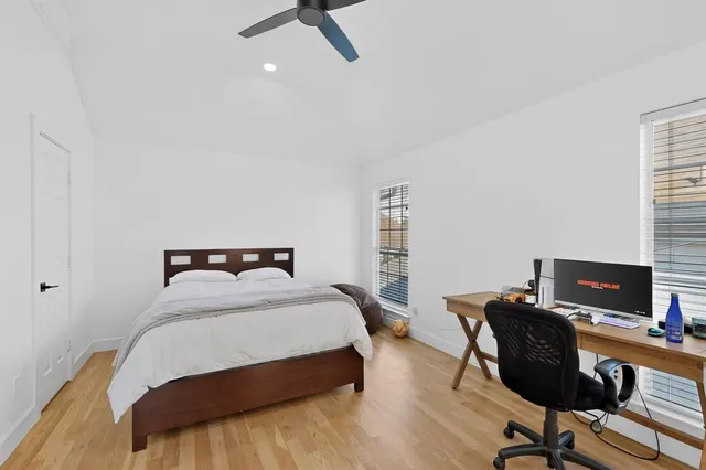 a bedroom with a bed and a desk