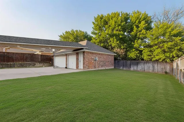 a backyard of a house with lots of green space and garden