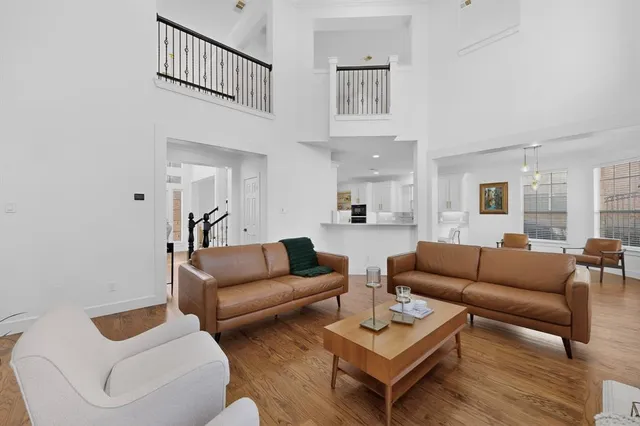 a living room with furniture a rug and a window