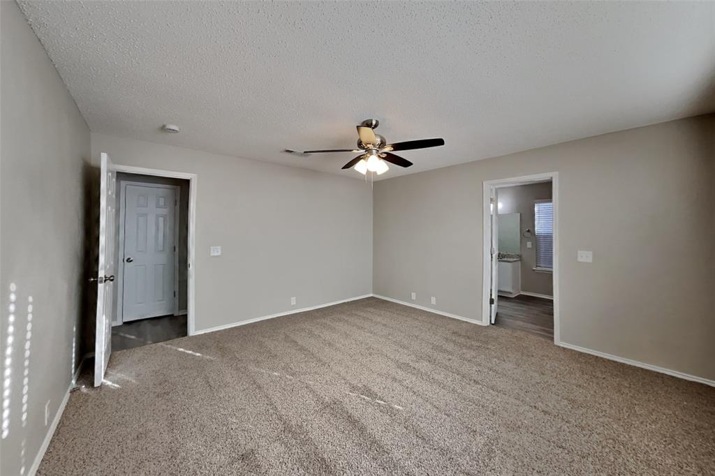 1320 Stetson Trail Saginaw, TX 76131 - Photo 6 of 19 a view of an empty room with a ceiling fan