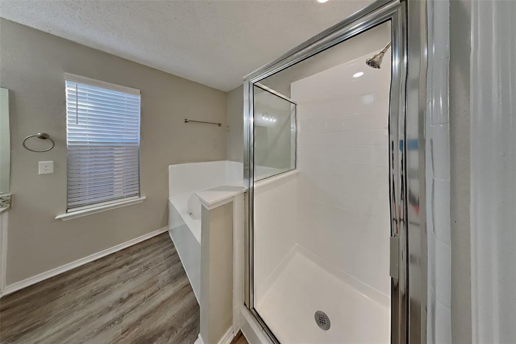 1320 Stetson Trail Saginaw, TX 76131 - Photo 8 of 19 a bathroom with a sink a glass door shower and a mirror