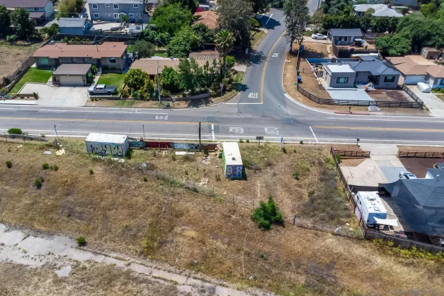 an aerial view of a house with a yard and parking space