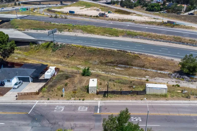 an aerial view of a house with a yard and lake view