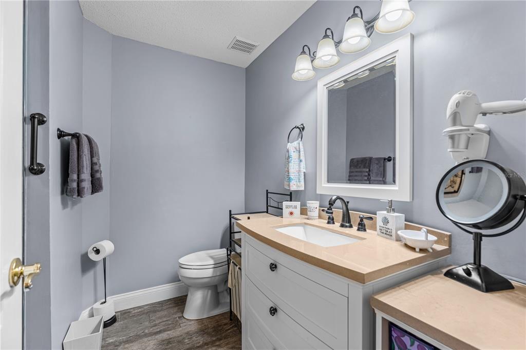 124 Rose Bank Road Daytona Beach, FL 32114 - Photo 30 of 43 a bathroom with a toilet a sink and a mirror