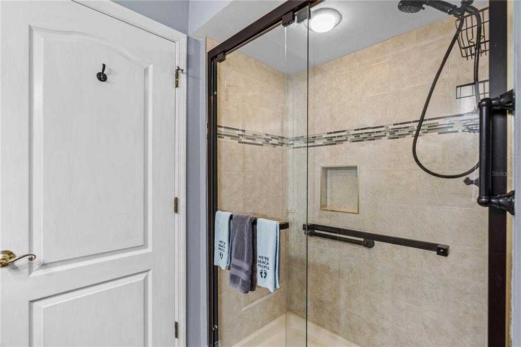 124 Rose Bank Road Daytona Beach, FL 32114 - Photo 31 of 43 a bathroom with a glass shower door