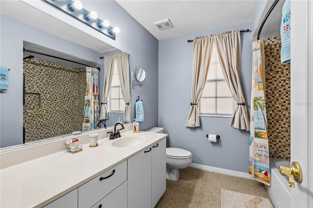 124 Rose Bank Road Daytona Beach, FL 32114 - Photo 38 of 43 a bathroom with a double vanity sink mirror and toilet