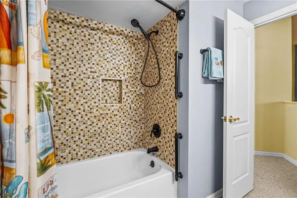 a bathroom with a bathtub and shower