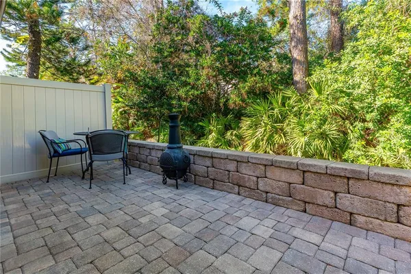 a backyard of a house with table and chairs