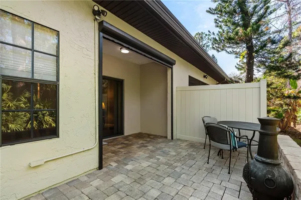 a backyard of a house with table and chairs
