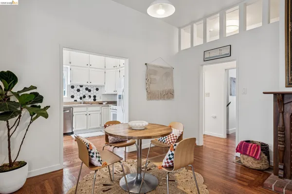 a dining room with furniture a chandelier and wooden floor