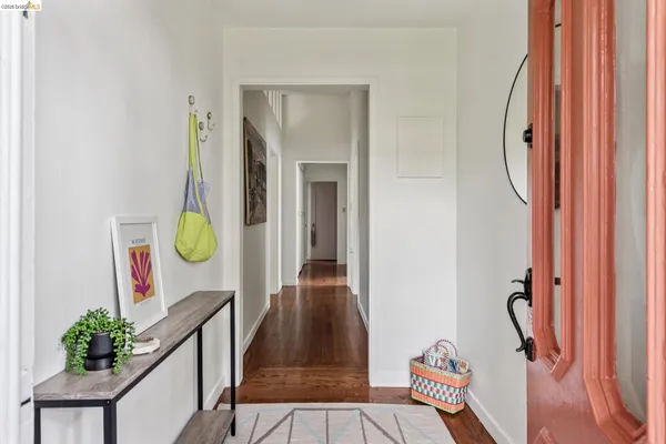 a view of a hallway with wooden floor and entryway