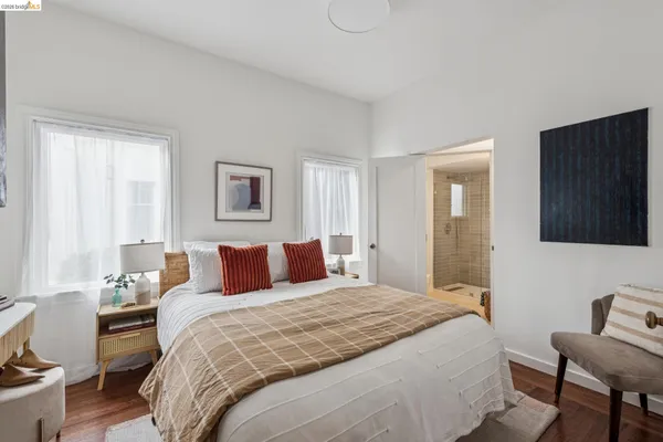 a bedroom with a bed and a potted plant