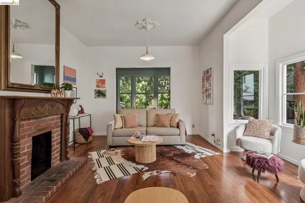 a living room with furniture fireplace and a large window