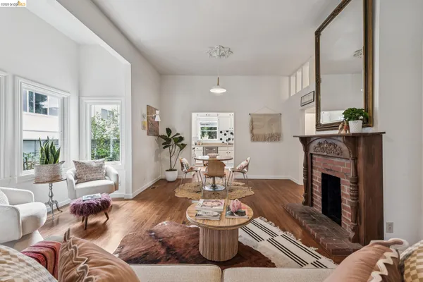 a living room with furniture a fireplace and a large window
