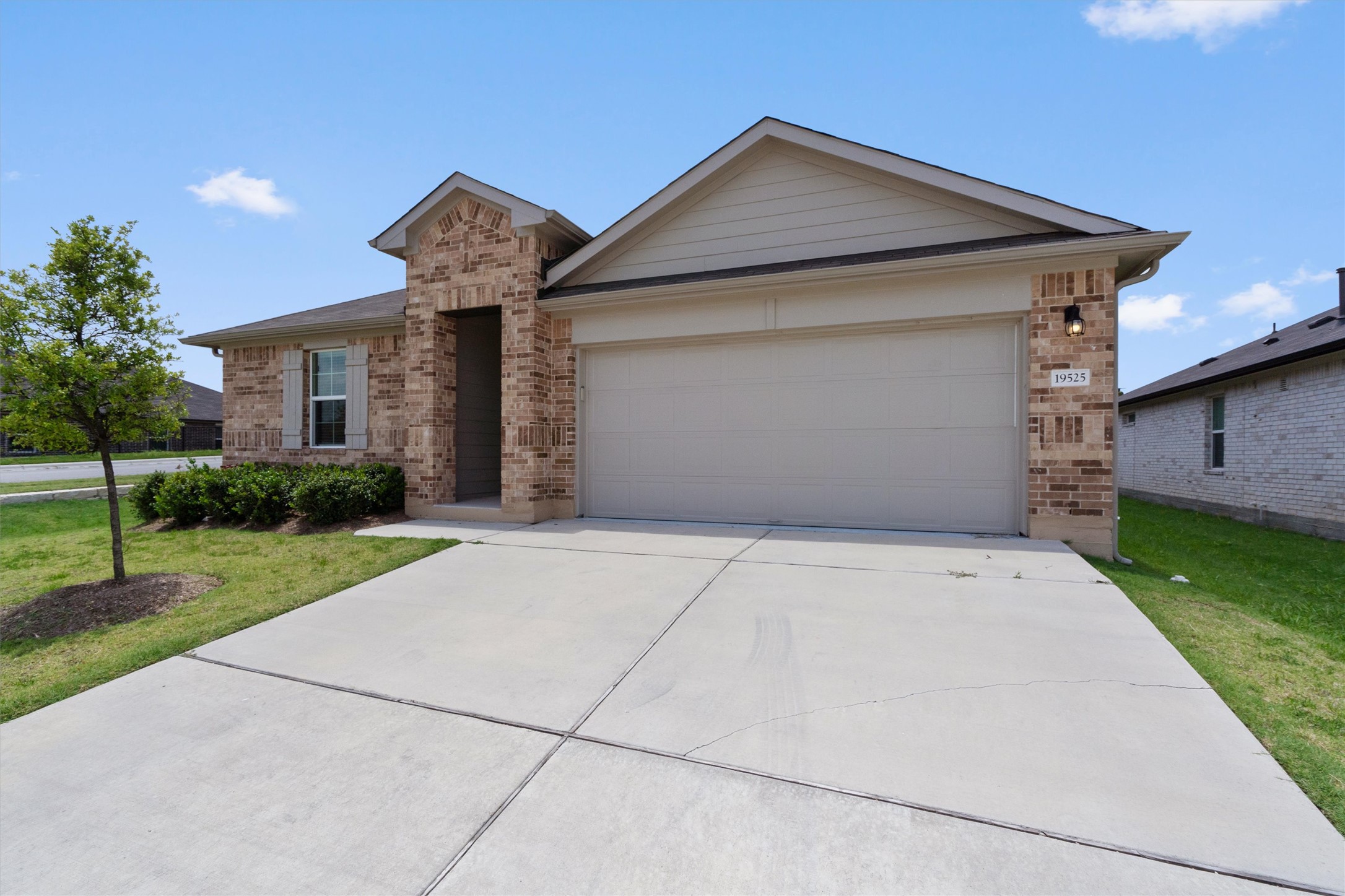 19525 Abigail Fillmore Road Manor, TX 78653 - Photo 4 of 38 A classic brick exterior offers timeless curb appeal and a well-maintained yard.