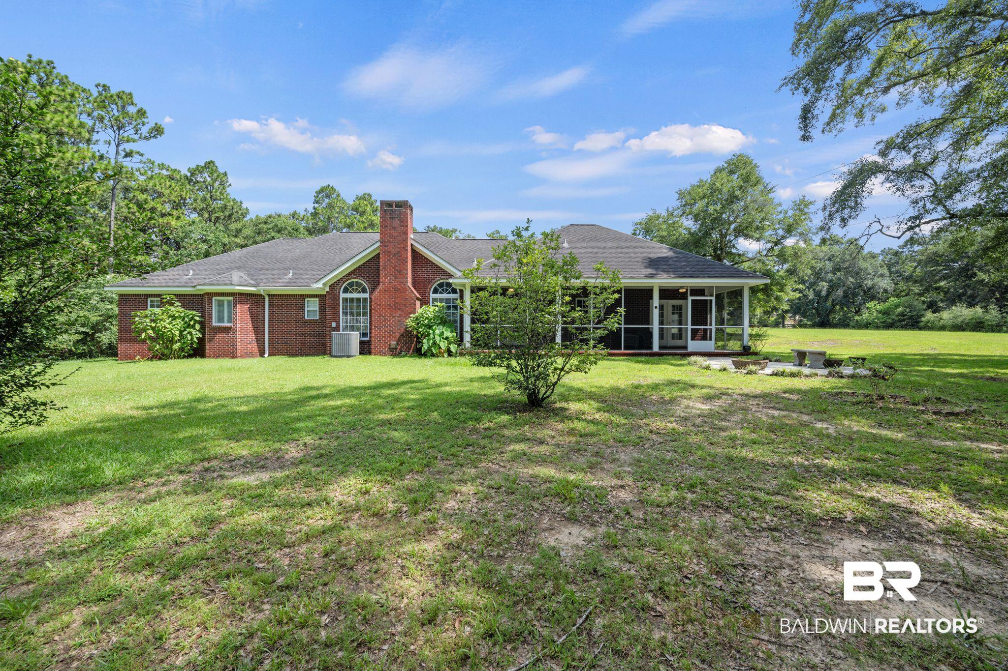 5618 Leytham Road Theodore, AL 36582 - Photo 43 of 60 View of front of house featuring a sunroom and a front lawn